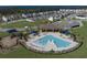 A beautiful pool area with splash pad, playground, picnic, seating, palm trees, and community neighborhood at 7779 Trapani Loop, Clermont, FL 34714