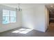Bright dining room with a chandelier, carpet floors, and natural sunlight from a large window at 7779 Trapani Loop, Clermont, FL 34714