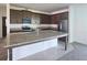 Open kitchen featuring granite countertops, stainless steel appliances, and ample cabinet space at 7779 Trapani Loop, Clermont, FL 34714