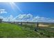 Scenic landscape view with green grass and clear blue skies at 7779 Trapani Loop, Clermont, FL 34714