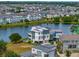 Beautiful modern home by the lake, surrounded by lush greenery and other residences at 8157 Elion St, Orlando, FL 32827