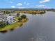Aerial view of a modern home with a pool, situated on a lakefront property at 8157 Elion St, Orlando, FL 32827