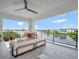Relaxing covered balcony featuring comfortable outdoor seating and a view of the beautiful lake at 8157 Elion St, Orlando, FL 32827