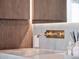 Close-up of the bathroom sink with gold fixtures and stylish wooden cabinets at 8157 Elion St, Orlando, FL 32827