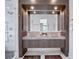 Modern bathroom with double sinks, ambient lighting, and a separate glass shower at 8157 Elion St, Orlando, FL 32827