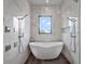 Spa-like bathroom features a freestanding tub, double shower heads, and luxurious finishes at 8157 Elion St, Orlando, FL 32827