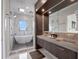 Elegant bathroom features double sinks, a rain head shower, and a modern bathtub at 8157 Elion St, Orlando, FL 32827