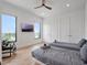 Cozy bedroom with twin beds, hardwood floors, and a serene view of the lake at 8157 Elion St, Orlando, FL 32827