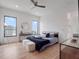 Comfortable bedroom featuring hardwood floors, closet space, and windows with neighborhood views at 8157 Elion St, Orlando, FL 32827