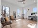 Spacious bedroom with hardwood floors, large windows, and comfortable seating area at 8157 Elion St, Orlando, FL 32827