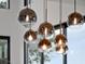 Close-up of a modern chandelier with elegant glass orbs and subtle lighting at 8157 Elion St, Orlando, FL 32827