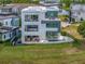 Modern three-story home featuring a pool, balconies, and outdoor living area, with a lake view at 8157 Elion St, Orlando, FL 32827