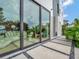 Modern home exterior with large sliding glass doors, outdoor shower, and landscaped walkway at 8157 Elion St, Orlando, FL 32827