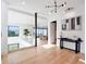 Bright foyer with hardwood floors, modern lighting, and an open floor plan flowing into the living area at 8157 Elion St, Orlando, FL 32827