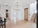 Bright foyer featuring modern lighting, white walls, light hardwood floors, and a floating staircase at 8157 Elion St, Orlando, FL 32827