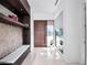 Modern foyer with a wooden door, built-in shelving, and a view to the exterior at 8157 Elion St, Orlando, FL 32827