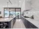 Modern kitchen with stainless steel appliances, quartz countertops, and a view of the water at 8157 Elion St, Orlando, FL 32827