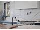 Modern kitchen featuring stainless steel appliances, quartz countertops, and water view at 8157 Elion St, Orlando, FL 32827