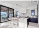 Modern kitchen featuring bar seating and sleek countertops with outdoor access at 8157 Elion St, Orlando, FL 32827