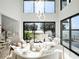 Bright, open living room with high ceilings, modern lighting, and a view of the lake at 8157 Elion St, Orlando, FL 32827