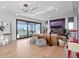 Bright living room featuring hardwood floors, stylish lighting, and a large sliding glass door at 8157 Elion St, Orlando, FL 32827