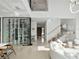 Open-concept living space with a wine display, floating staircase, and white tile flooring at 8157 Elion St, Orlando, FL 32827