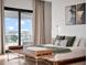 Bright main bedroom showcasing neutral decor, hardwood floors and view of the neighborhood at 8157 Elion St, Orlando, FL 32827