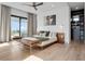 Bright main bedroom boasts a balcony, walk-in closet, and modern furnishings at 8157 Elion St, Orlando, FL 32827