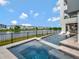 Upscale home showcasing a stylish pool and spa area with water features overlooking the lake at 8157 Elion St, Orlando, FL 32827