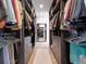 Spacious walk-in closet with well-organized racks, drawers, and a full length mirror at 8157 Elion St, Orlando, FL 32827