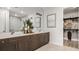 Bathroom featuring double sinks, modern fixtures, and a large mirror at 940 Club Cresswind Dr, Lady Lake, FL 32159