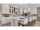 Modern kitchen featuring a central island with seating, stainless steel appliances, and white cabinetry at 940 Club Cresswind Dr, Lady Lake, FL 32159