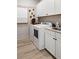 Well-equipped laundry room with modern washer and dryer and ample cabinet space at 940 Club Cresswind Dr, Lady Lake, FL 32159