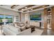 Bright living room features beamed ceilings, modern decor, and sliding glass doors to lanai at 940 Club Cresswind Dr, Lady Lake, FL 32159