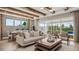 Open concept living room features a beamed ceiling and wall to wall sliders to the lanai at 940 Club Cresswind Dr, Lady Lake, FL 32159