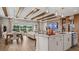 Open-concept living area with a kitchen island, wood beam ceiling, and a comfortable seating area at 940 Club Cresswind Dr, Lady Lake, FL 32159