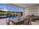 A screened pool area with tranquil waterfall features and a spacious dining area for outdoor entertaining at 940 Club Cresswind Dr, Lady Lake, FL 32159