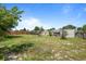 View of the large, partially-fenced backyard with grass and mature trees at 978 N Jerico Dr, Casselberry, FL 32707