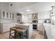 Modern kitchen featuring white cabinetry, stainless steel appliances, and a center island with seating at 978 N Jerico Dr, Casselberry, FL 32707