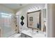 Bathroom with shower-tub, vanity, large mirror, and modern fixtures at 100 Demens St, Oakland, FL 34760