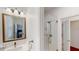 Bright bathroom featuring a glass shower and white vanity with modern fixtures at 100 Demens St, Oakland, FL 34760