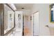 Bathroom with a large vanity, mirror, and view into the next room at 100 Demens St, Oakland, FL 34760
