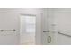 Modern bathroom with glass shower enclosure, grab bars, and window, providing safety and natural light at 100 Demens St, Oakland, FL 34760