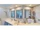 Bathroom featuring double sinks, granite counters, tiled walls, and a shower at 100 Demens St, Oakland, FL 34760