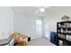 Bright bedroom featuring neutral carpet, reading chair, and a black bookcase against the wall at 100 Demens St, Oakland, FL 34760