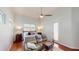 Bright bedroom with a ceiling fan, wood floors, and a comfortable seating area at 100 Demens St, Oakland, FL 34760