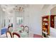 Bright dining area features a glass table set, elegant chandelier, and display cabinet on hardwood floors at 100 Demens St, Oakland, FL 34760