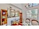 Dining room with glass table, wood floors, chandelier, and mirrored wall at 100 Demens St, Oakland, FL 34760