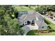 Stunning single-Gathering home features a screened-in pool, spacious driveway, and lush landscaping at 100 Demens St, Oakland, FL 34760