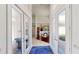 Bright foyer with glass doors leads to dining room with chandelier and hardwood floors at 100 Demens St, Oakland, FL 34760